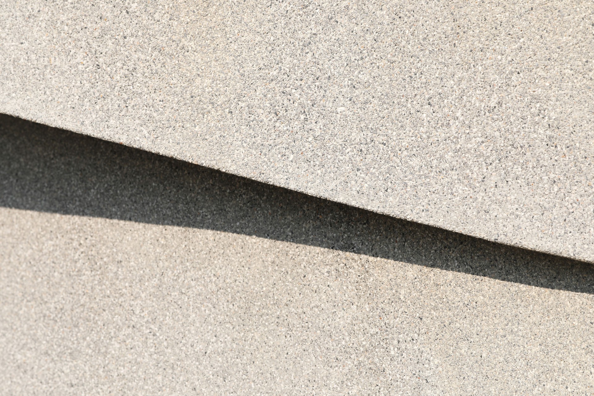 Abstract background from shadow on gravel wall.